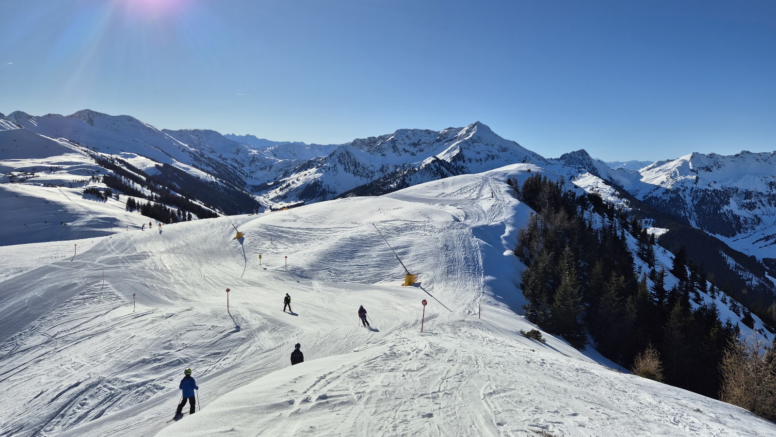 Traditional Tyrolean chalets and a church in snowy Alpbach village