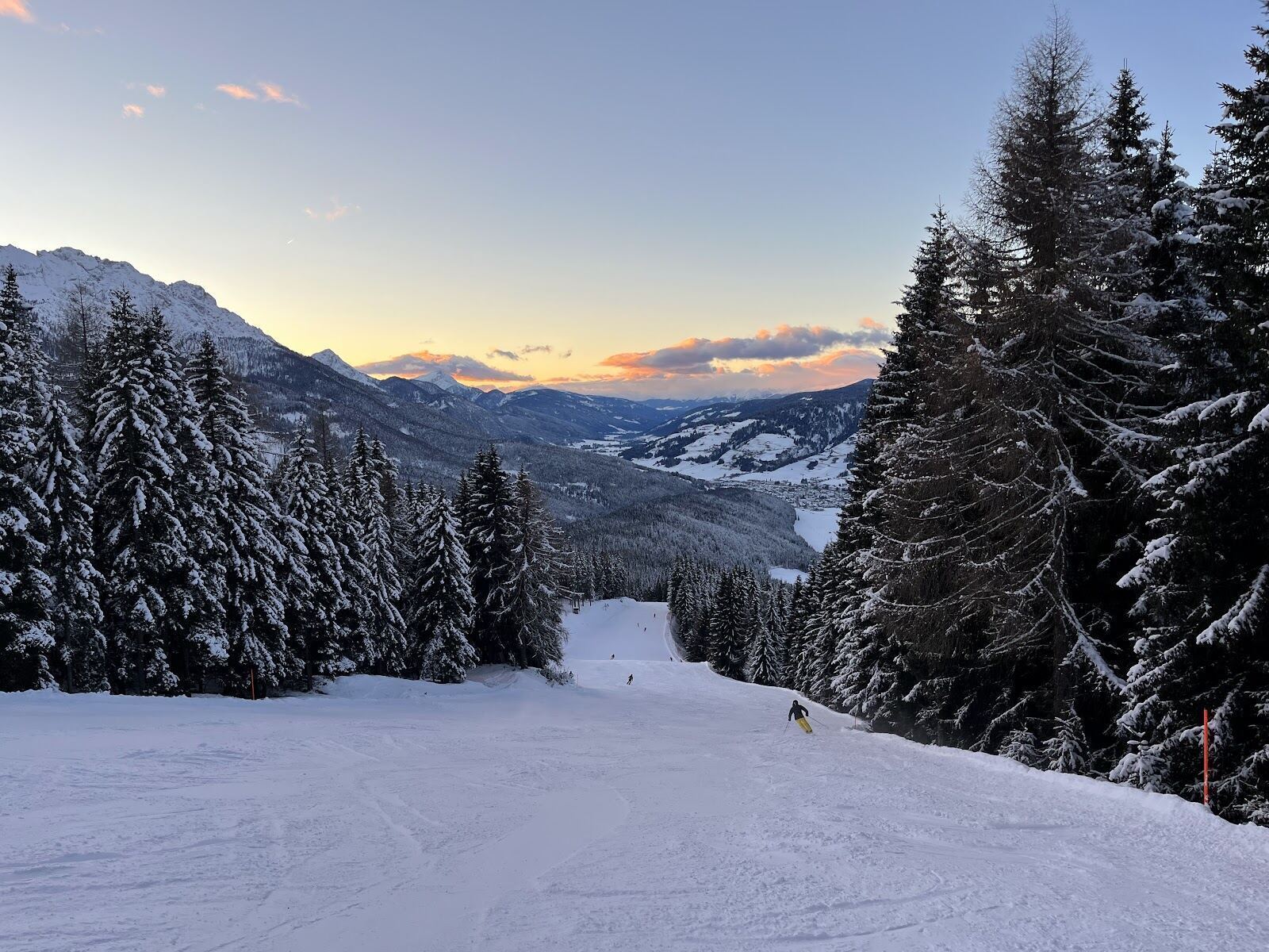 The town of San Candido in the snow with Dolomite peaks behind