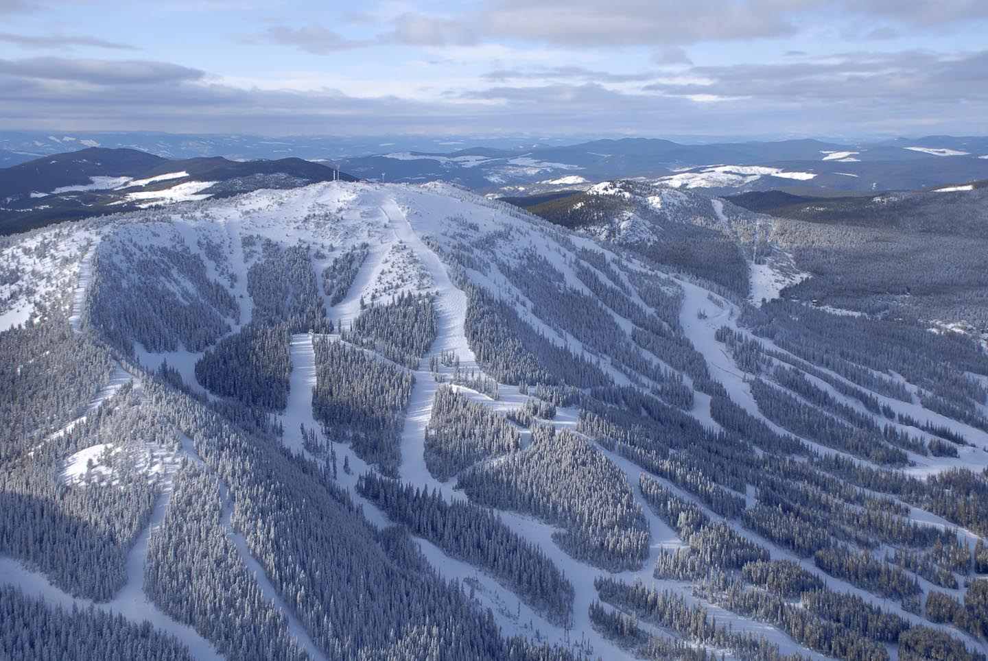 Snowy slopes and trees at Apex Mountain Resort in British Columbia
