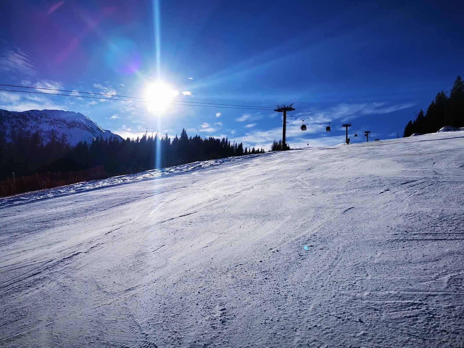 The sunny ski slopes above Aprica in the Valtellina under a clear winter sky