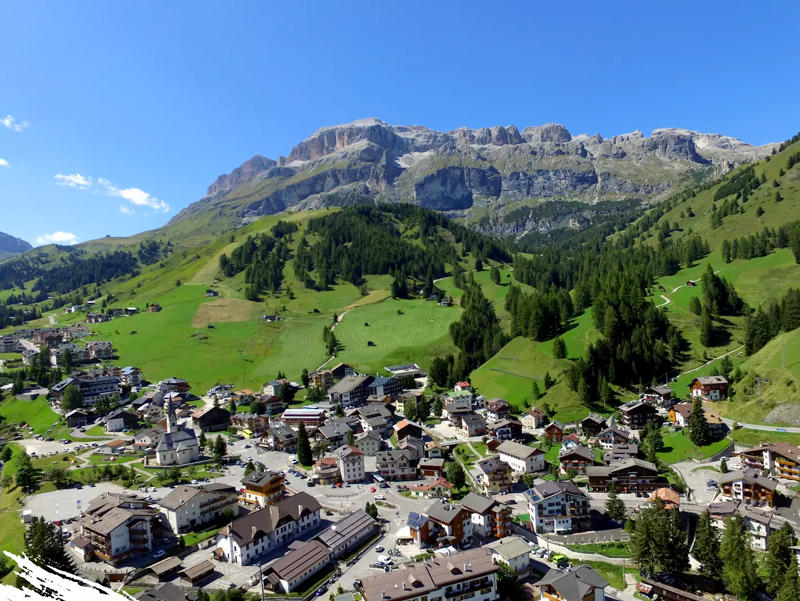 The high Dolomites village of Arabba under snow with the Marmolada glacier behind