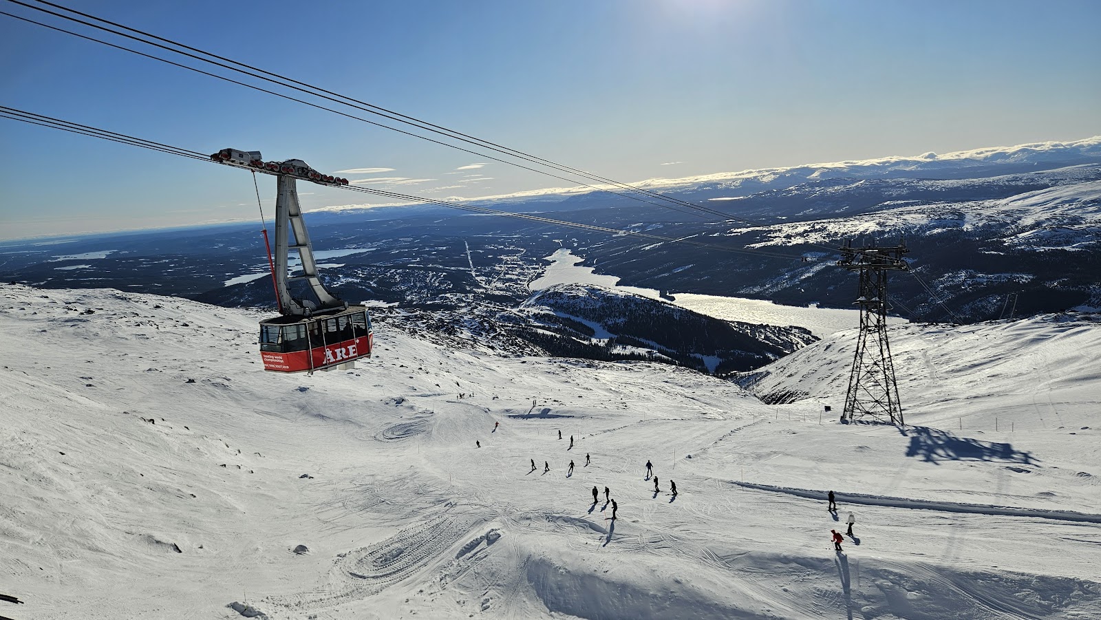 Skiers on open pistes above the treeline at Are