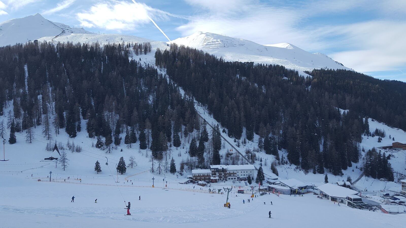 A chairlift rising over the Axamer Lizum slopes toward the summit