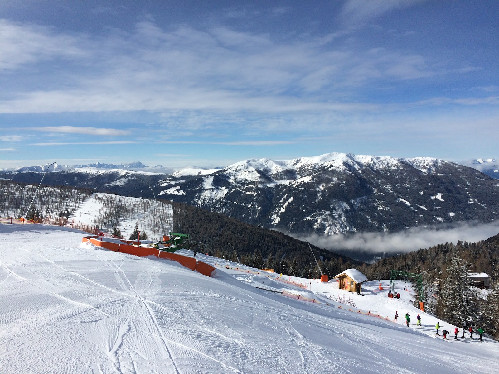 Sunny well groomed pistes above Bad Kleinkirchheim with forest and peaks