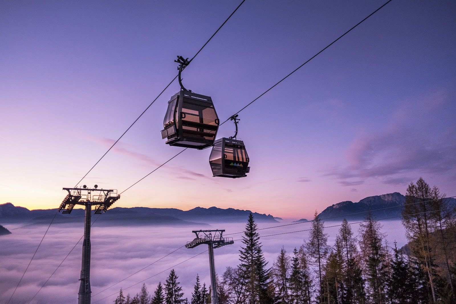 The Jenner gondola rising above the emerald Lake Konigssee in winter