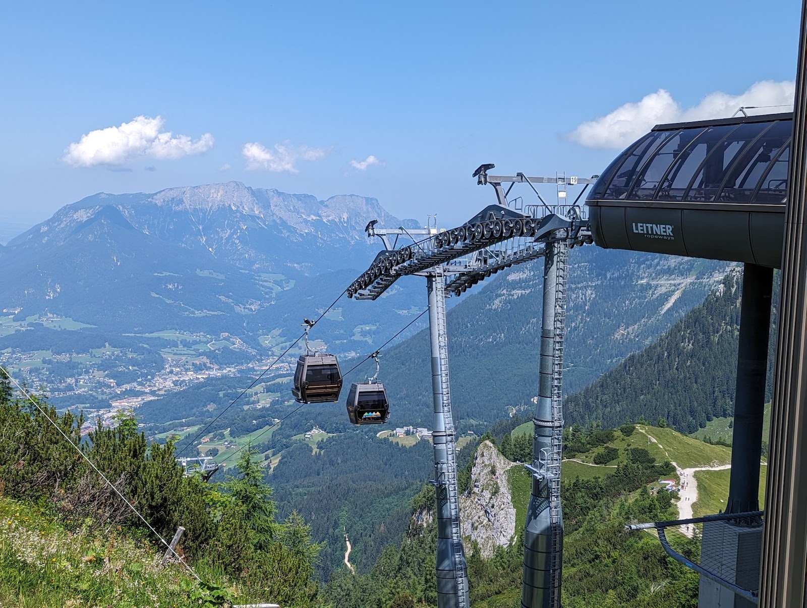 Skiers on a sunny piste above the Berchtesgaden valley