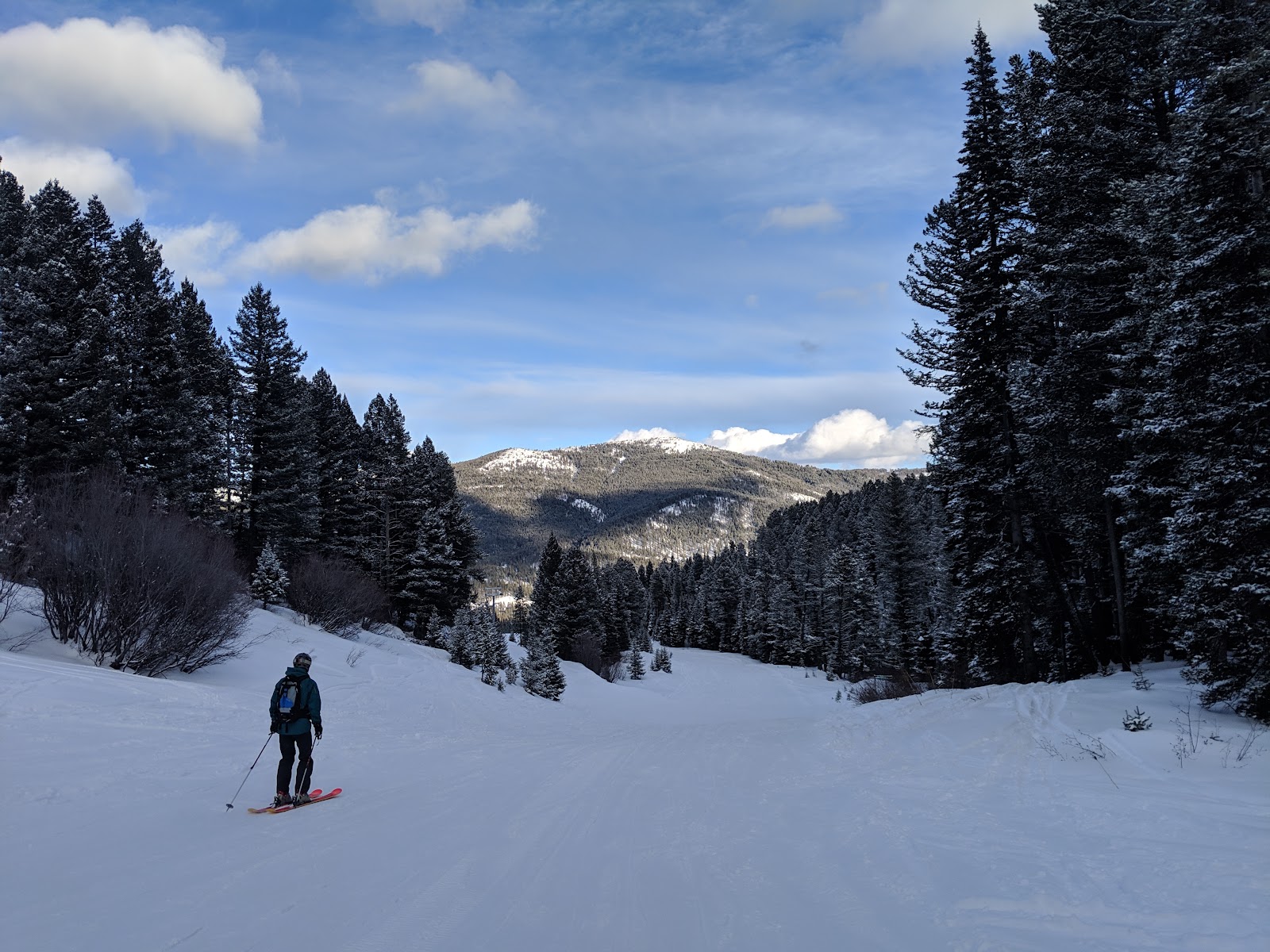 Skiers riding a chairlift on a sunny winter day
