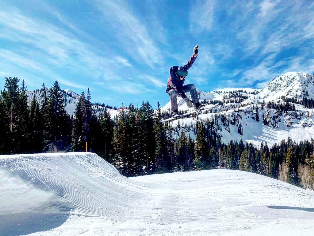 A chairlift rising over snowy open bowls at Brighton
