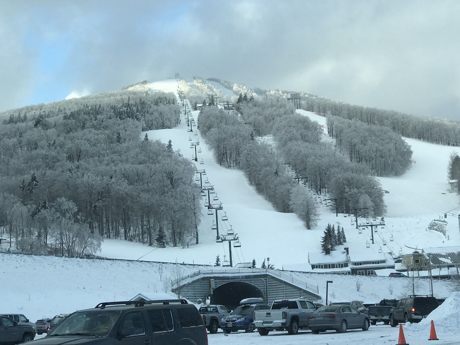 Chairlift and snowy slopes above the base lodge at Bromley