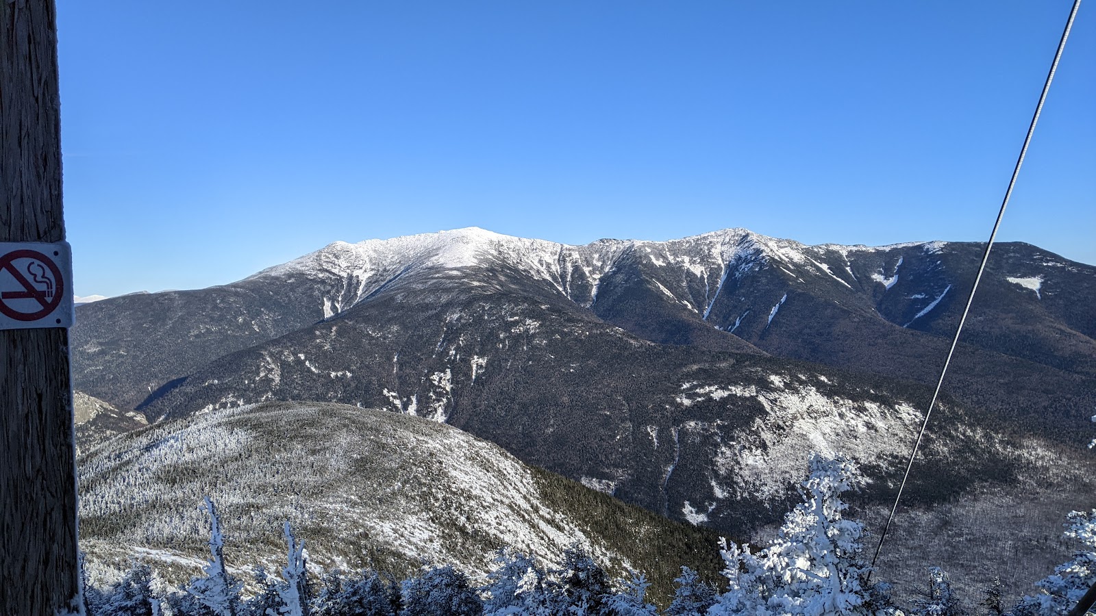 A snowy New England mountainside of evergreen forest at Cannon Mountain