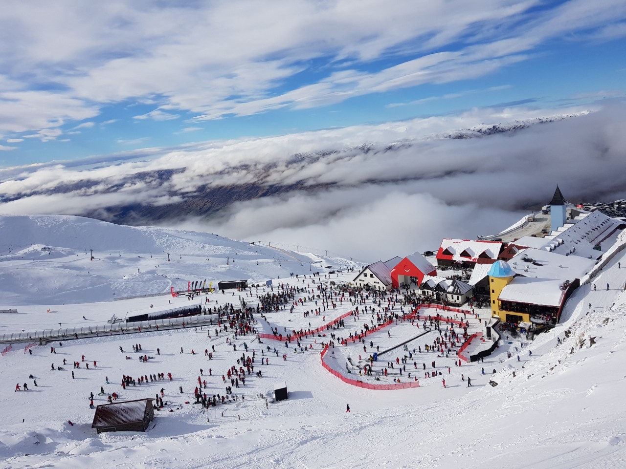 Wide sunny groomed basins and chairlifts at Cardrona Alpine Resort in New Zealand