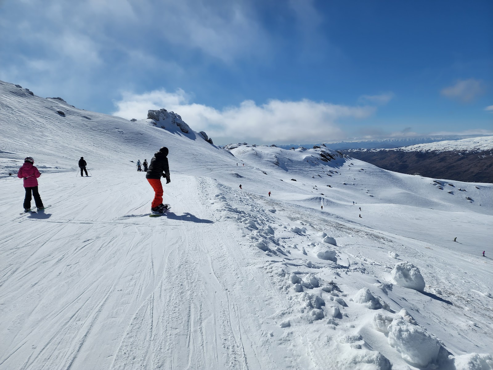 Terrain park jumps and rails under blue sky at Cardrona Alpine Resort