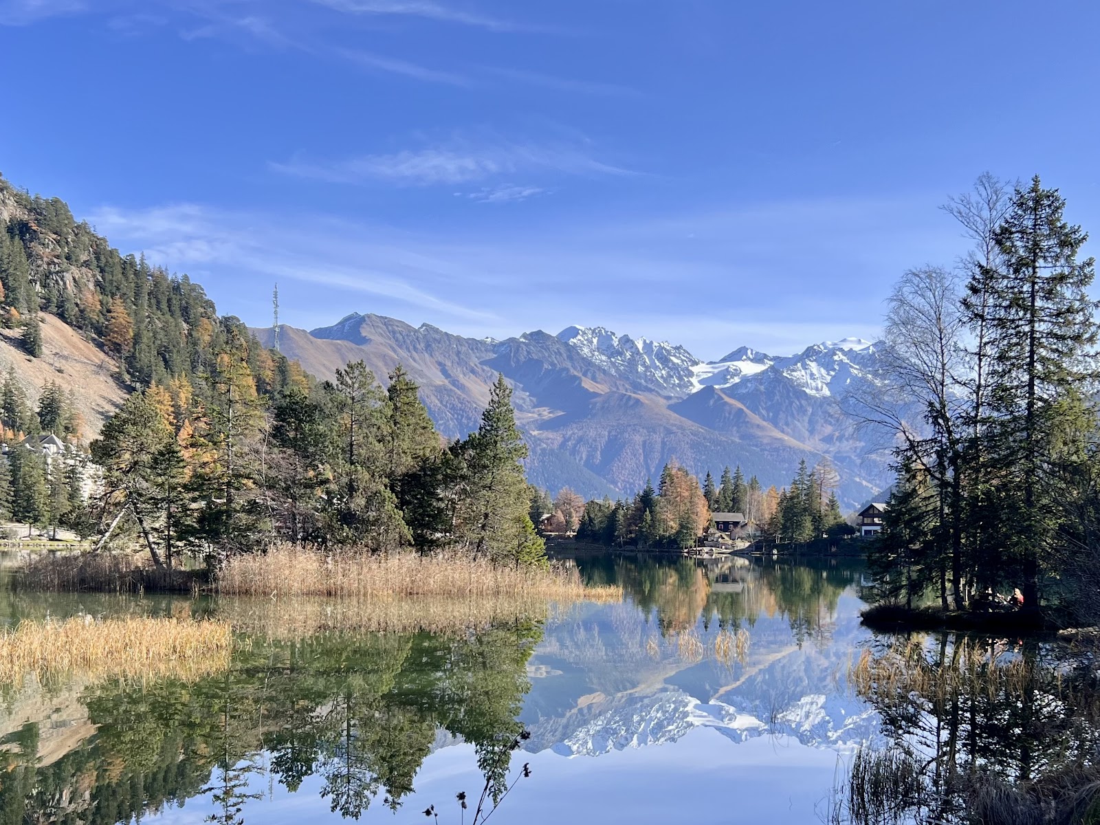 The frozen lake at Champex Lac ringed by snowy peaks under winter sun