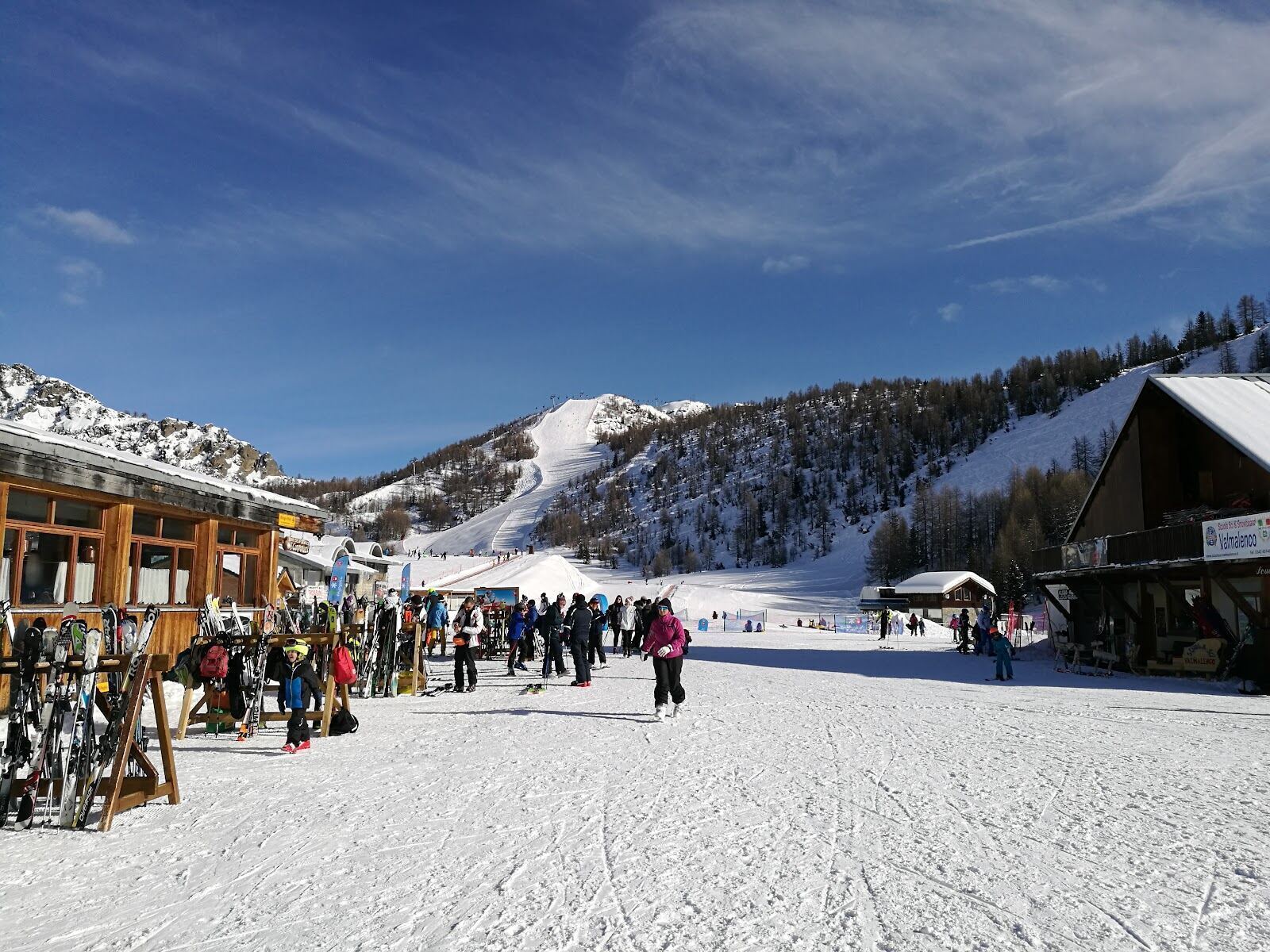 Skiers on a quiet groomed piste above Chiesa in Valmalenco