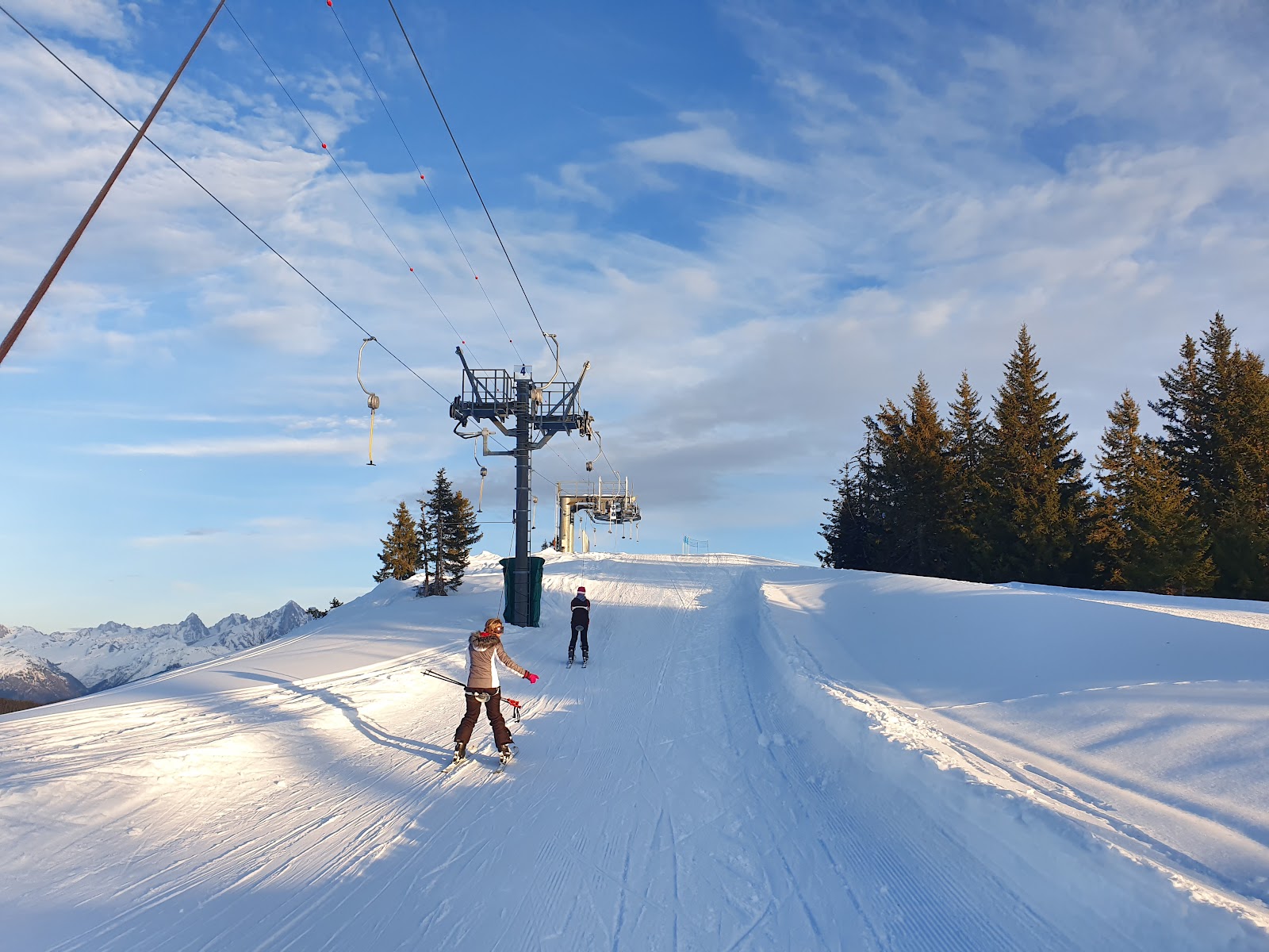 Sunny gentle pistes above Combloux on a clear winter day