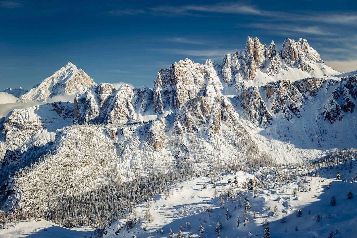 The town of Cortina d'Ampezzo below the pink limestone Dolomite peaks in winter