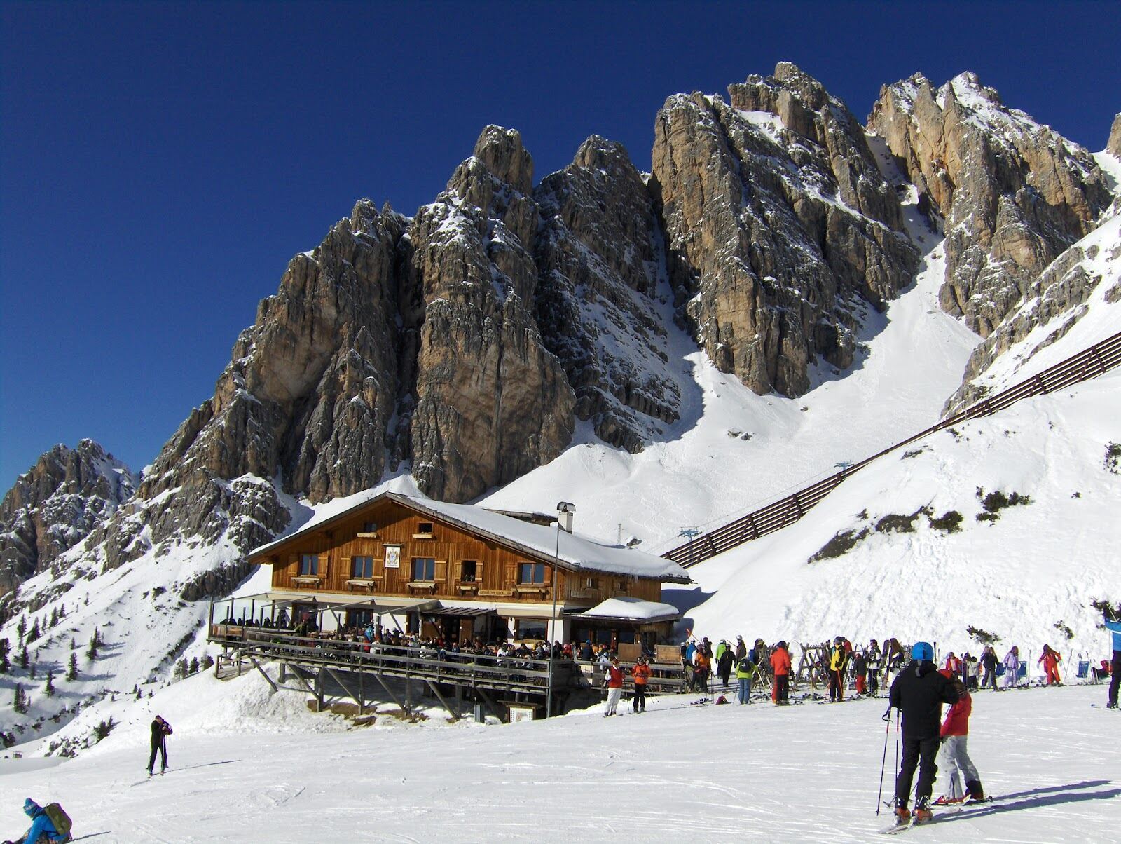 A wide sunlit groomed piste above Cortina d'Ampezzo