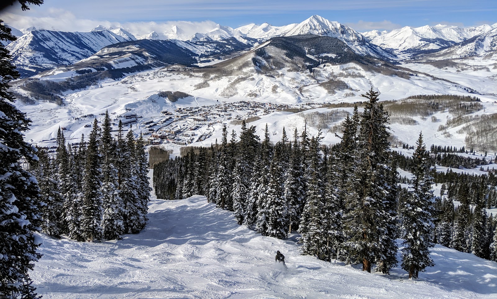 A skier in deep powder in the trees at Crested Butte