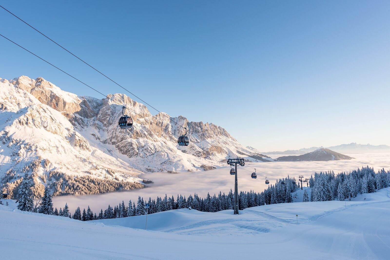 A chairlift rising over sunny Hochkonig slopes near Dienten