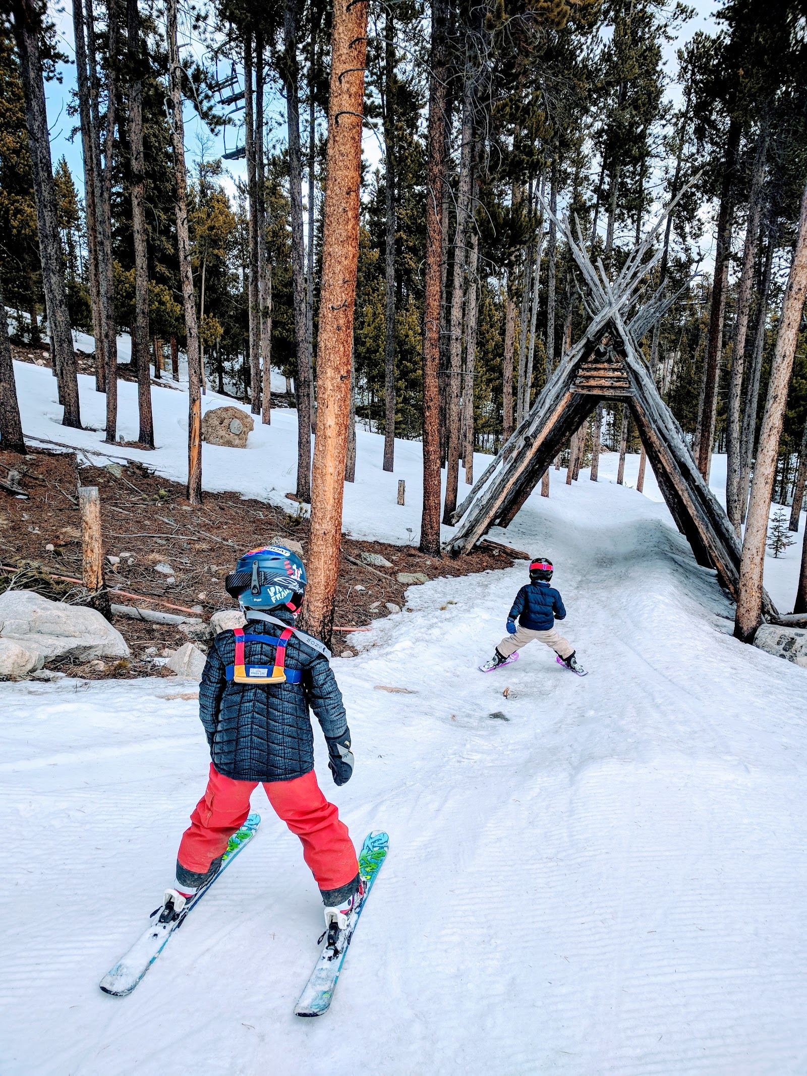 Skier carving a groomed run on a bright Colorado day