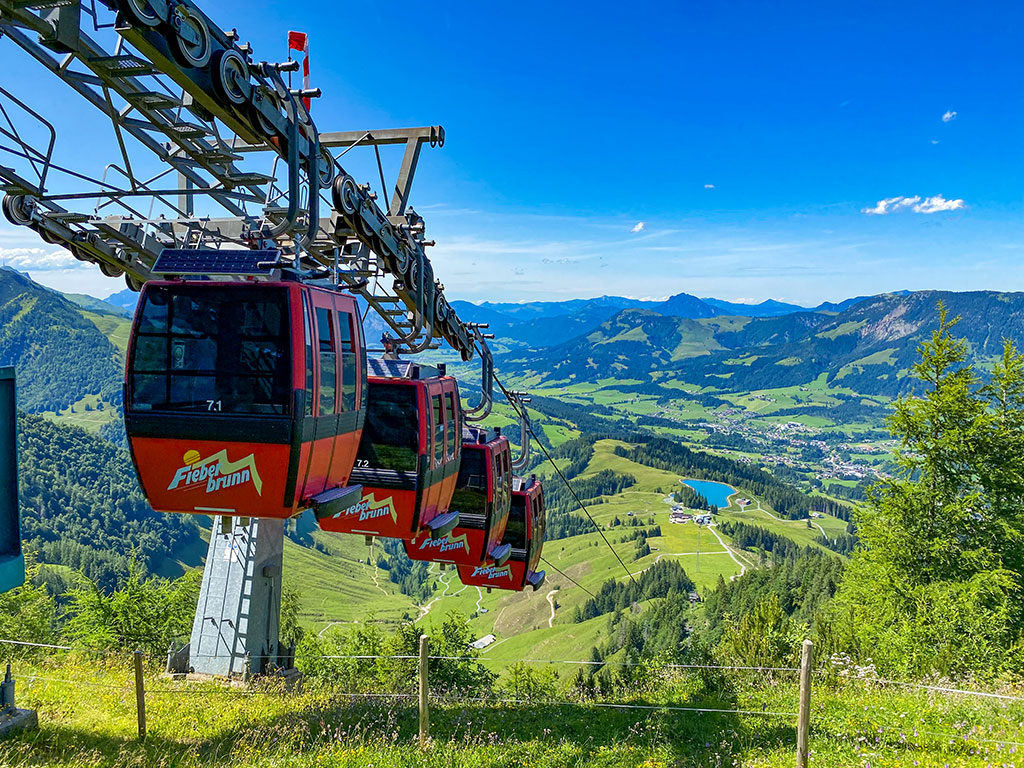 Skiers riding powder off the marked runs at Fieberbrunn