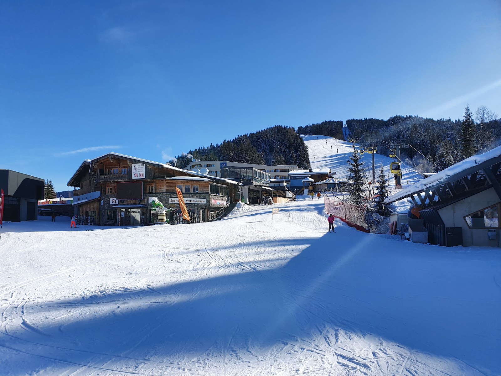 The village of Fieberbrunn below snowy forested slopes
