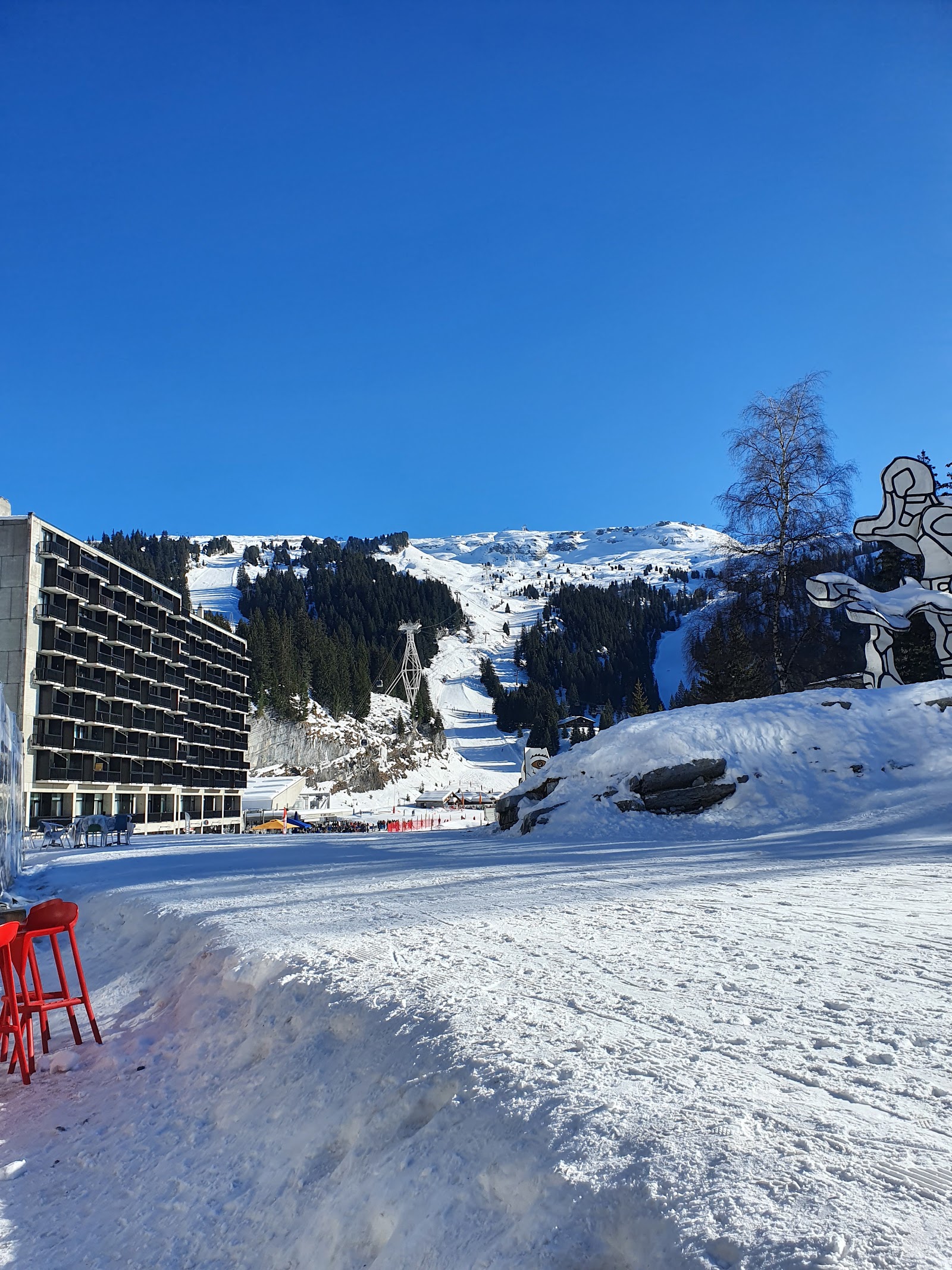 Skiers riding a chairlift above the Grand Massif