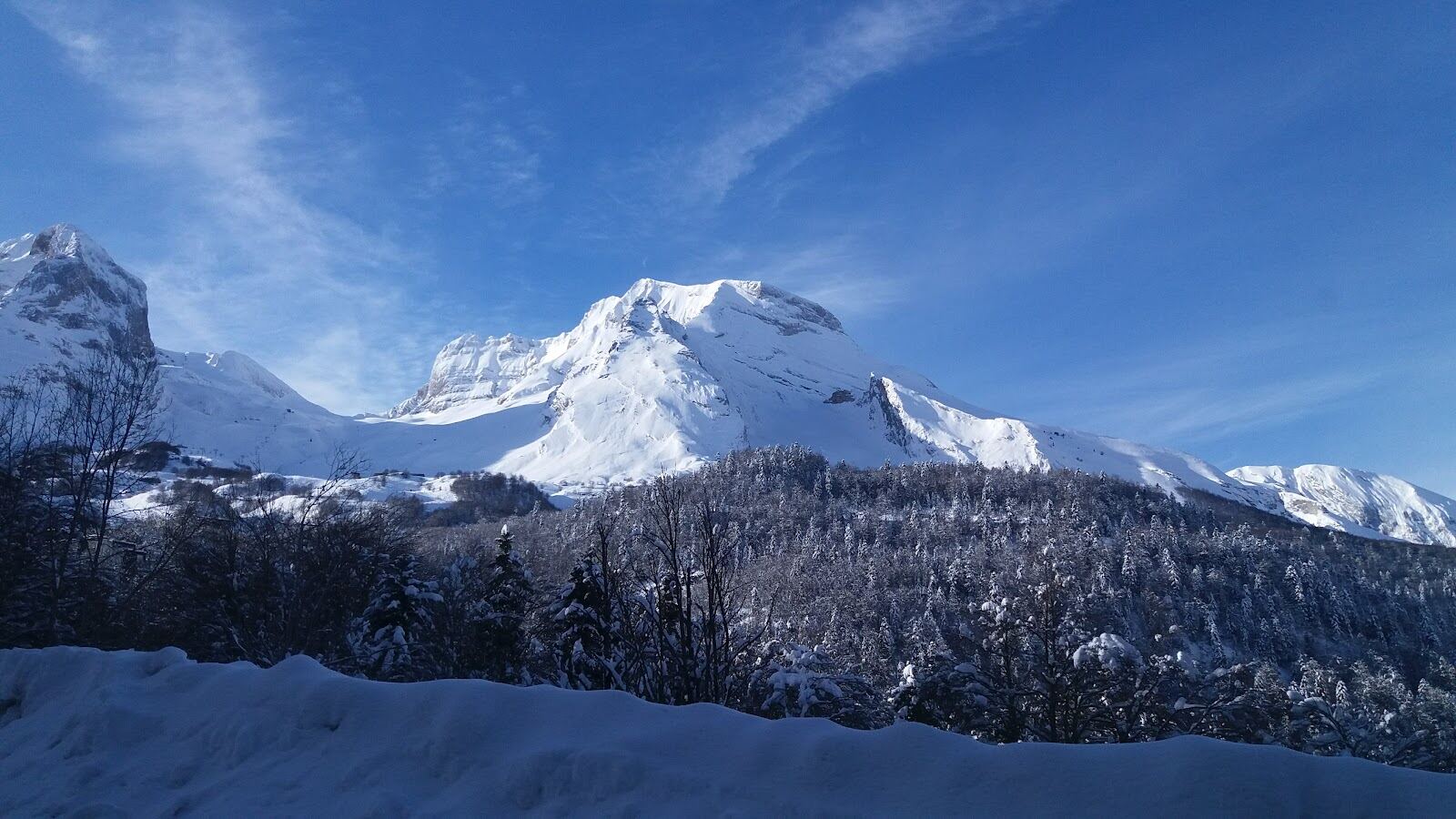 Skiers on the slopes above the Ossau valley at Gourette