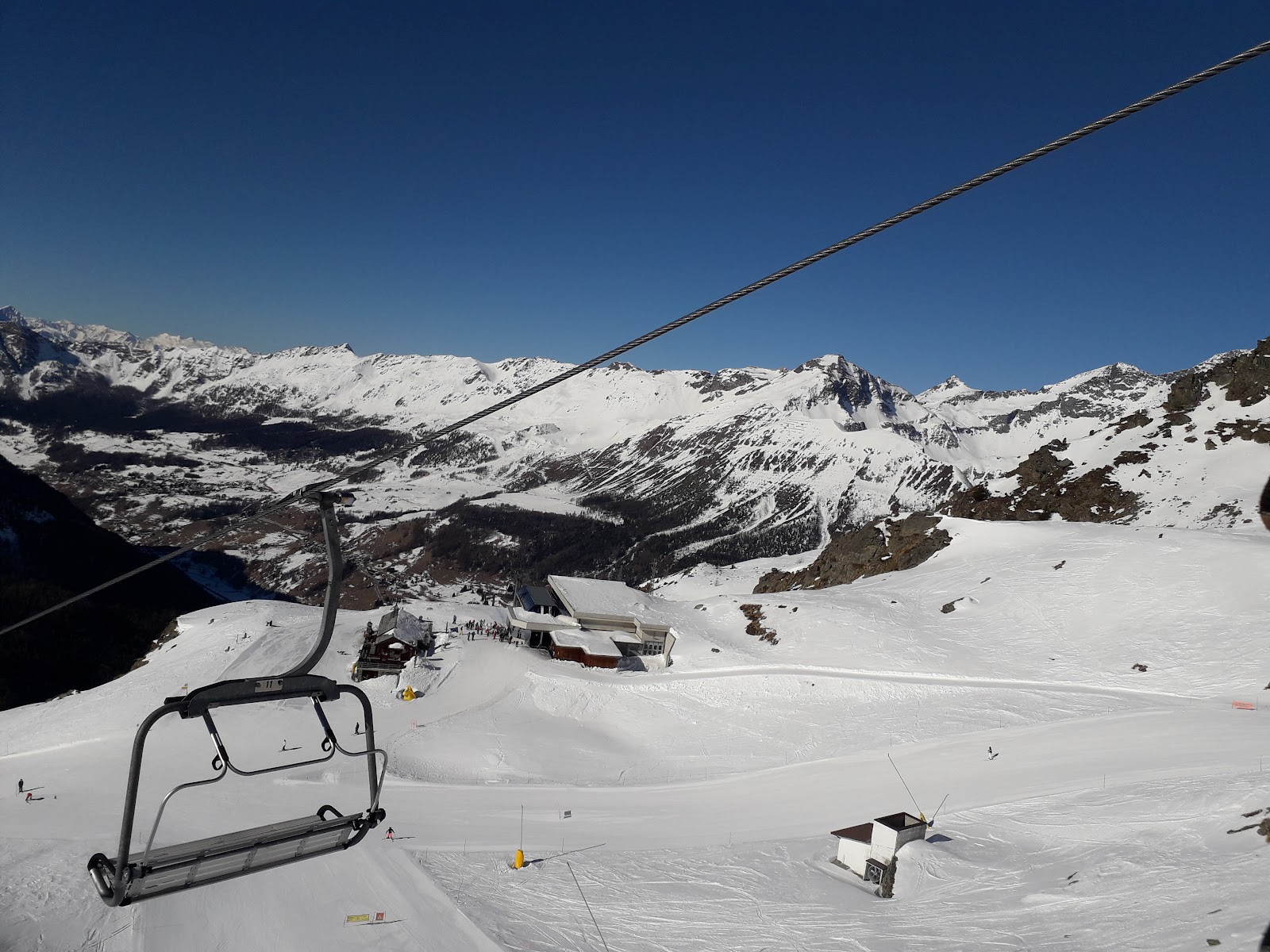 A skier carving a high sunny Monterosa piste above Gressoney