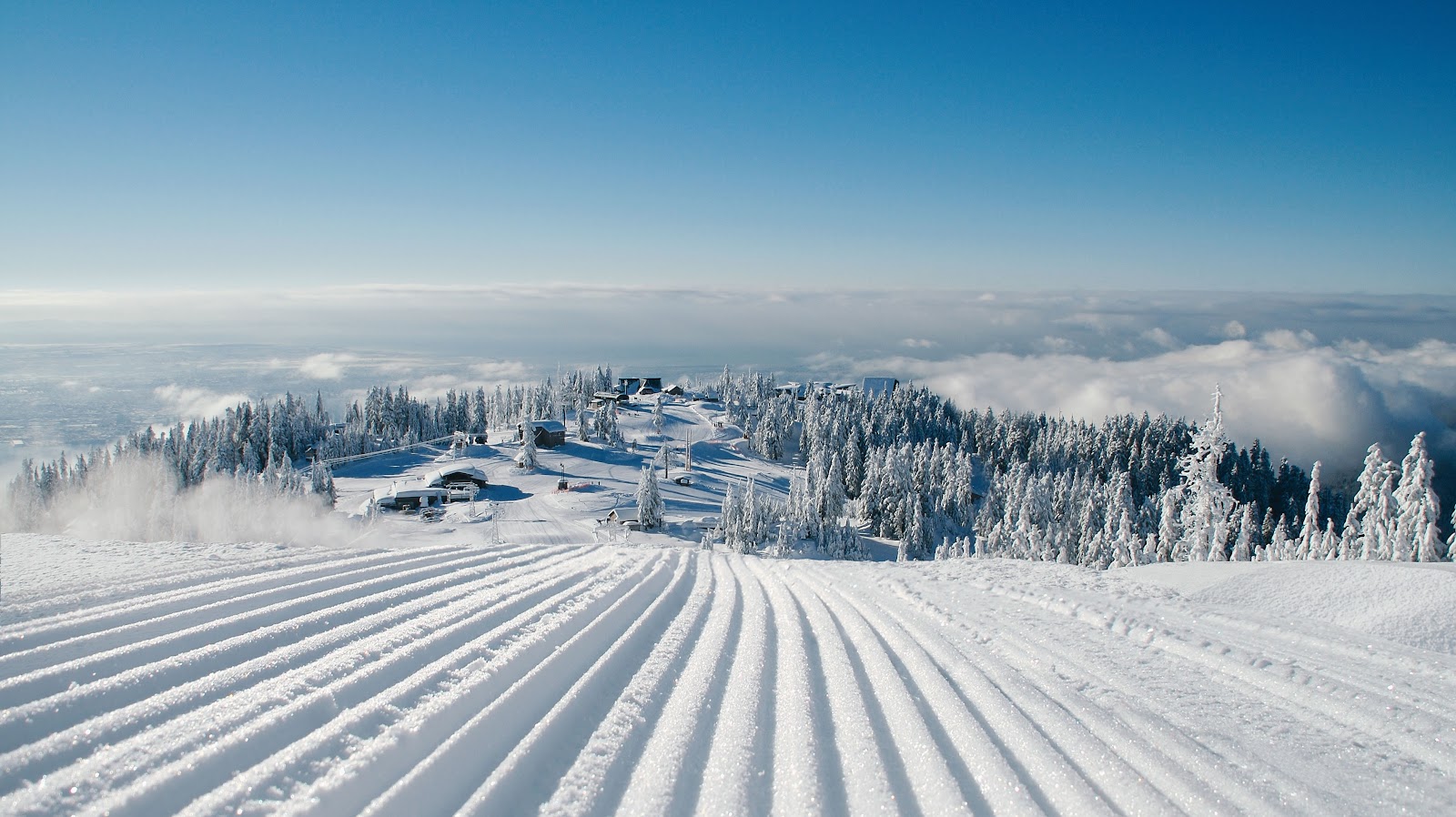 Floodlit ski runs above the lights of Vancouver at night