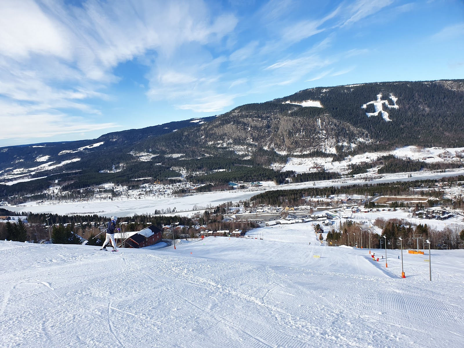 Skiers riding a chairlift over snowy slopes at Hafjell