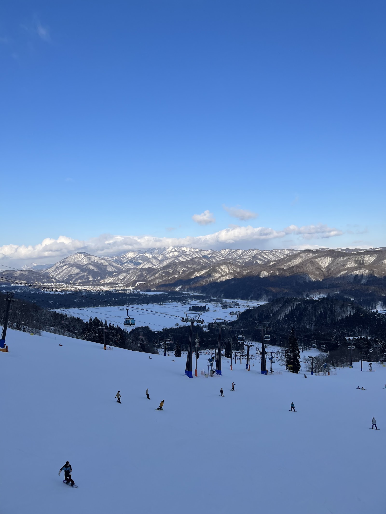 Tree lined slopes and chairlift at the connected Hakuba 47