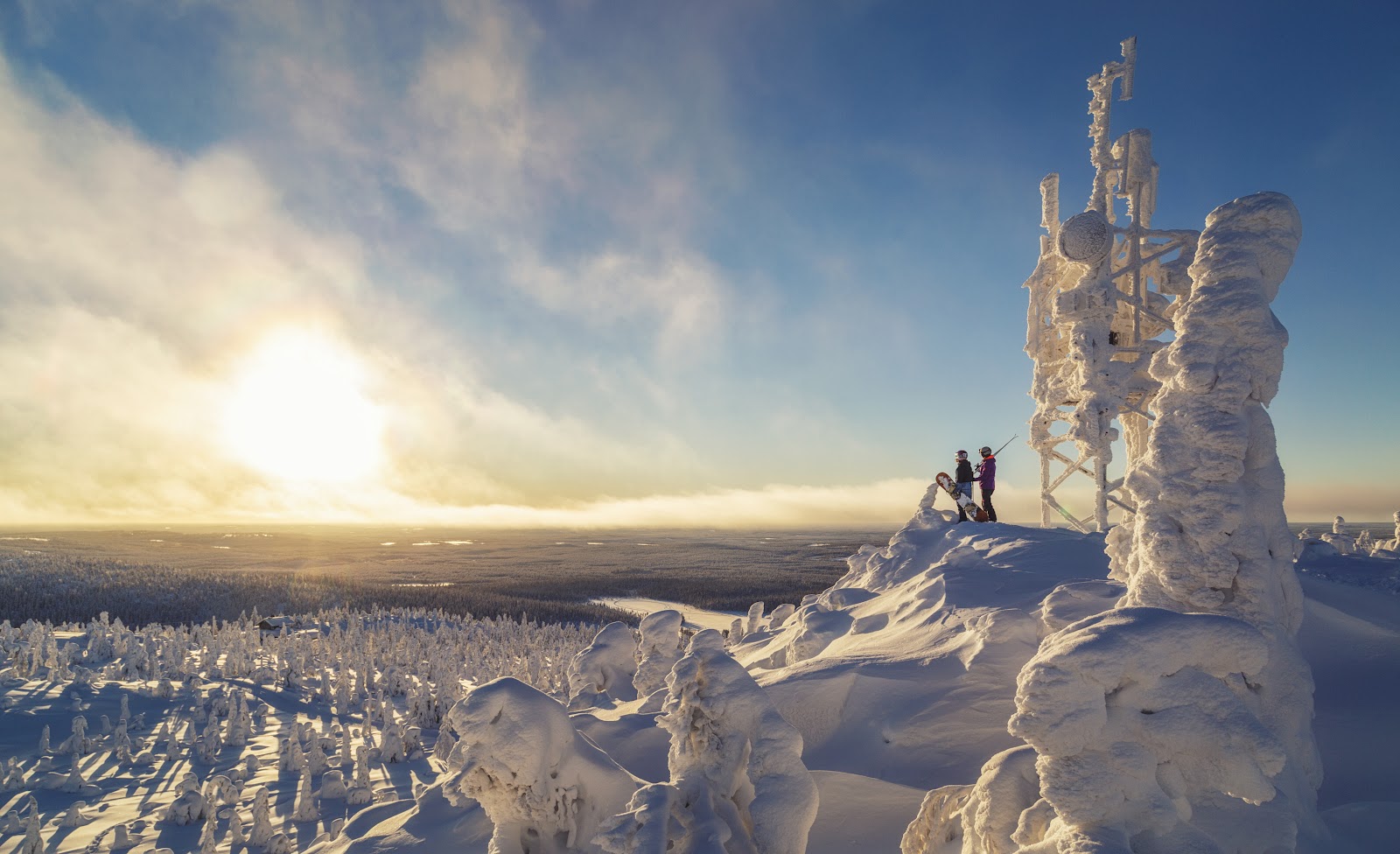 Snow covered spruce forest and floodlit slopes on the Iso Syote fell in Finland