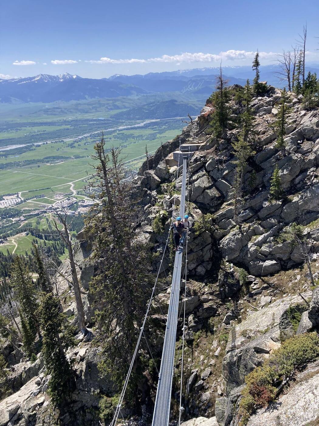 A skier dropping into a steep powder chute at Jackson Hole