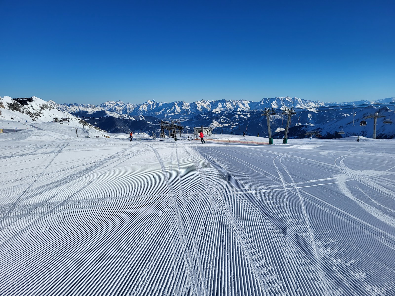 Skiers on the linked slopes above Zell am See and the lake