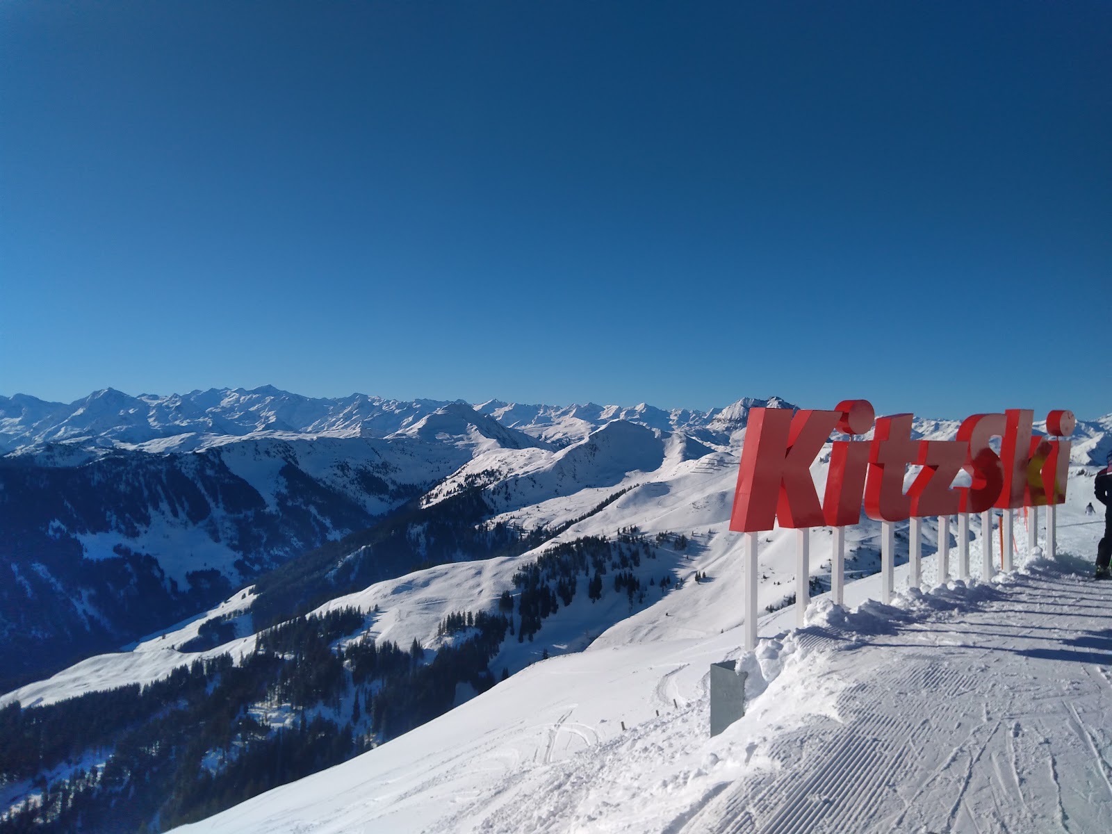 The village of Kirchberg in Tirol with church and snowy peaks