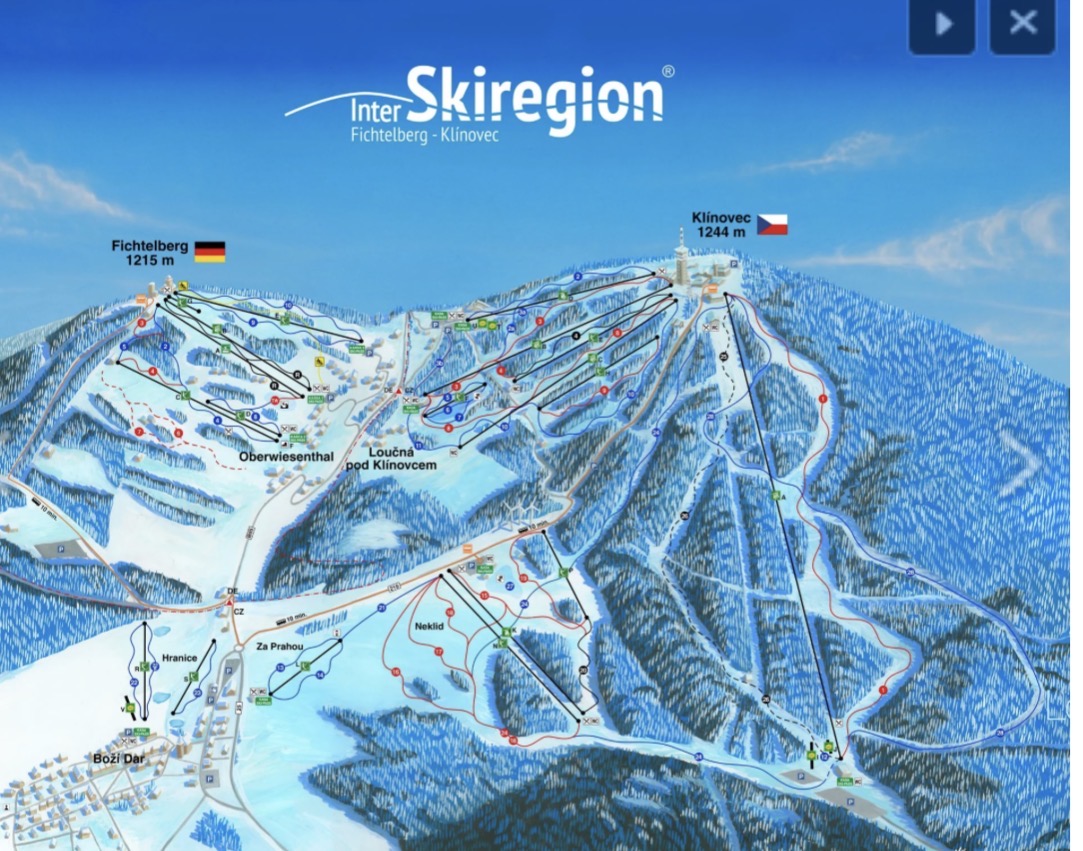 Snow covered slopes and forest at the Klinovec ski area