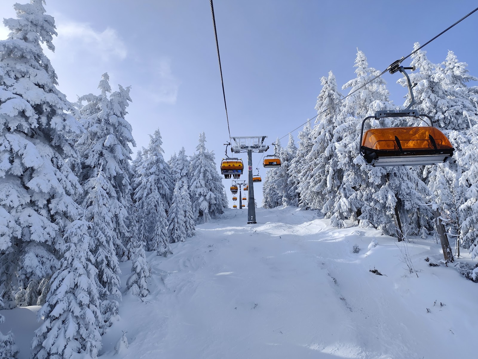 Skiers and a chairlift at Klinovec near the German border