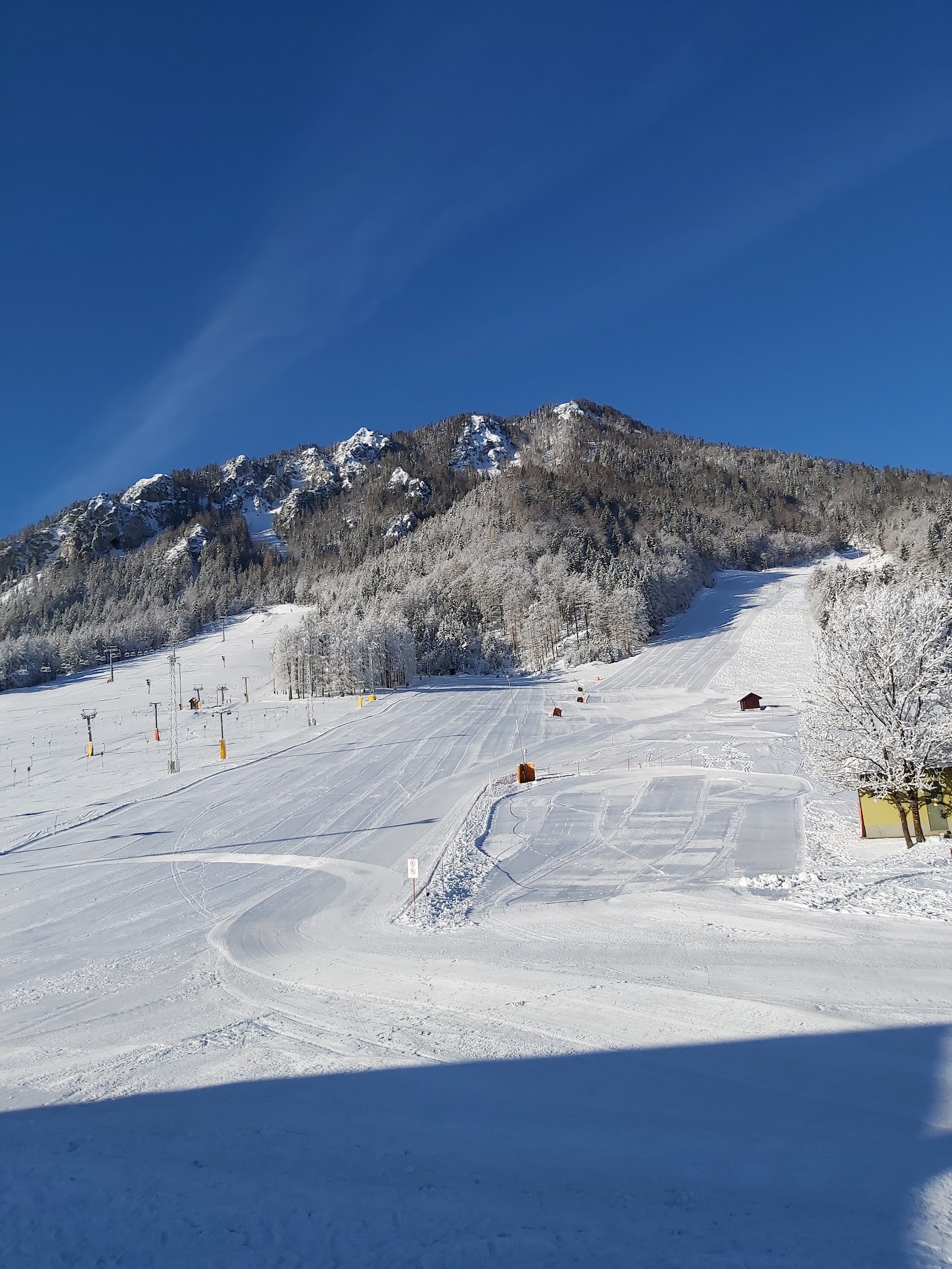Snowy pistes below the Julian Alps peaks at Kranjska Gora in Slovenia
