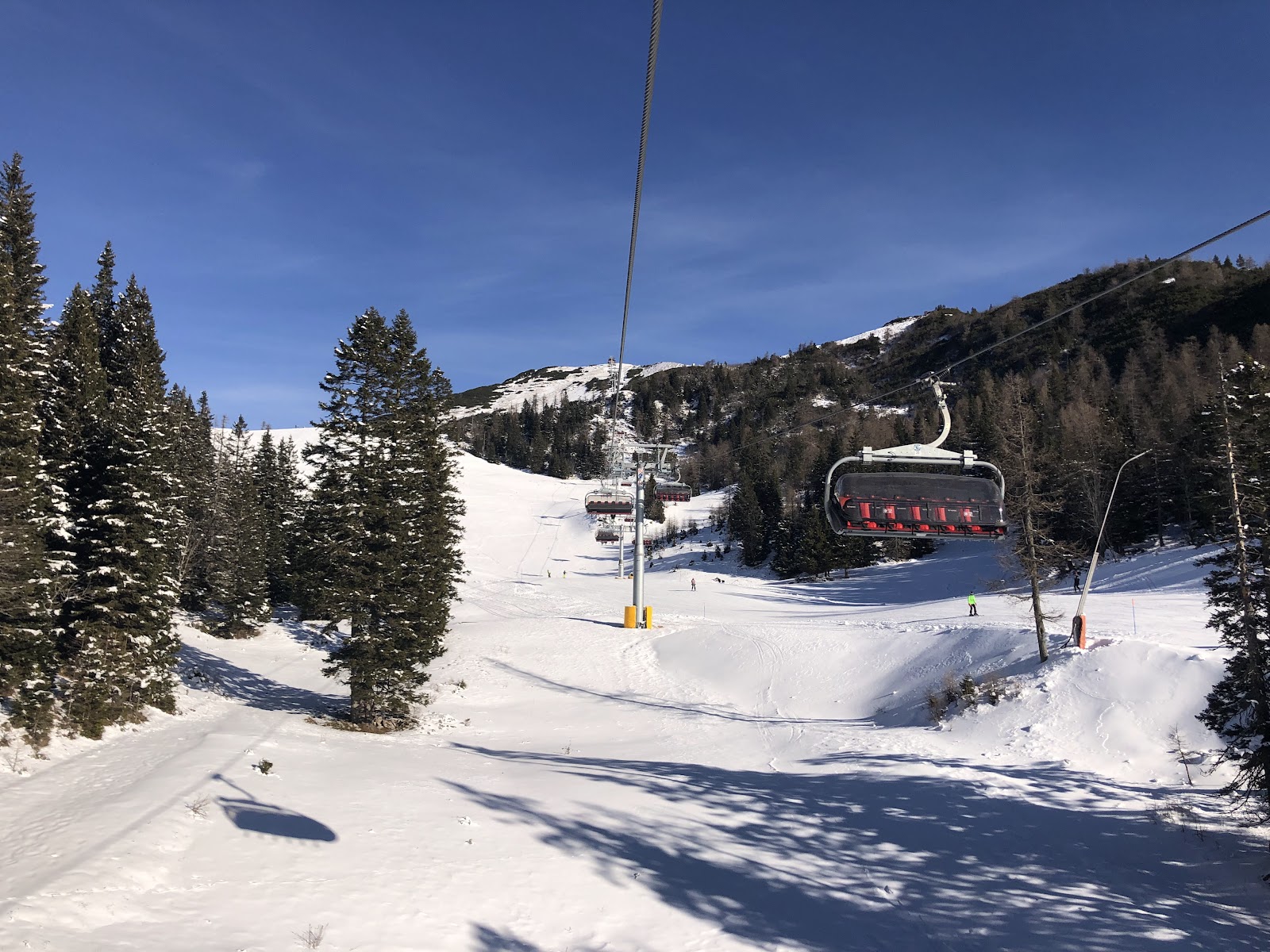 Gondola and snowy slopes with valley views at Krvavec