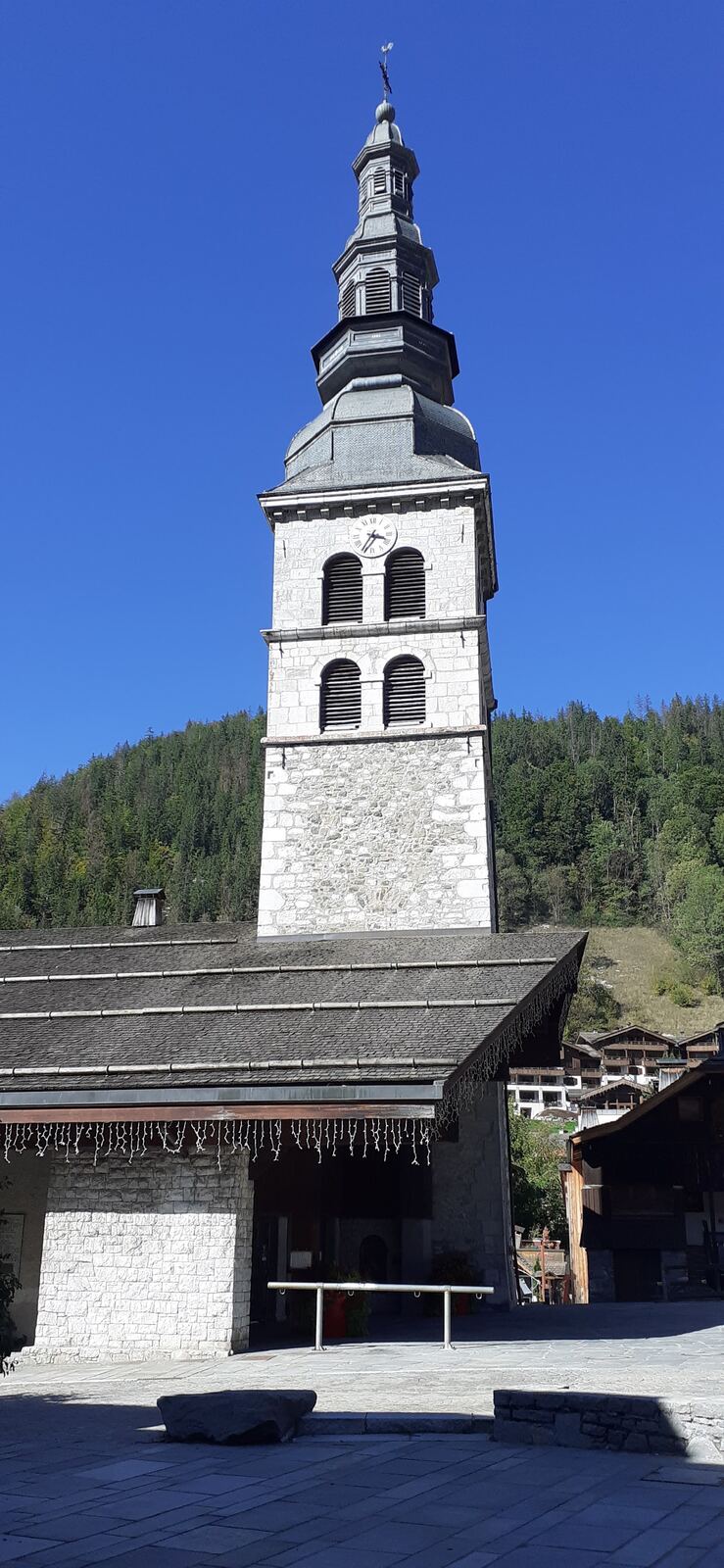 The church and snowy main street in the center of La Clusaz