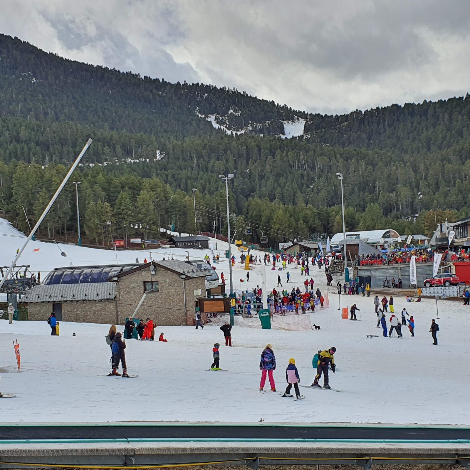 Resort base buildings and learner area busy with families