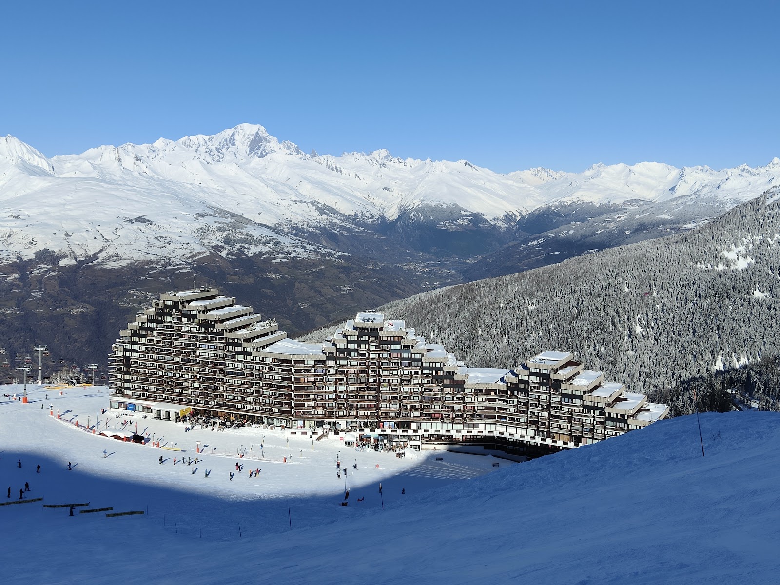 A high French ski village in La Plagne under deep snow with gentle slopes