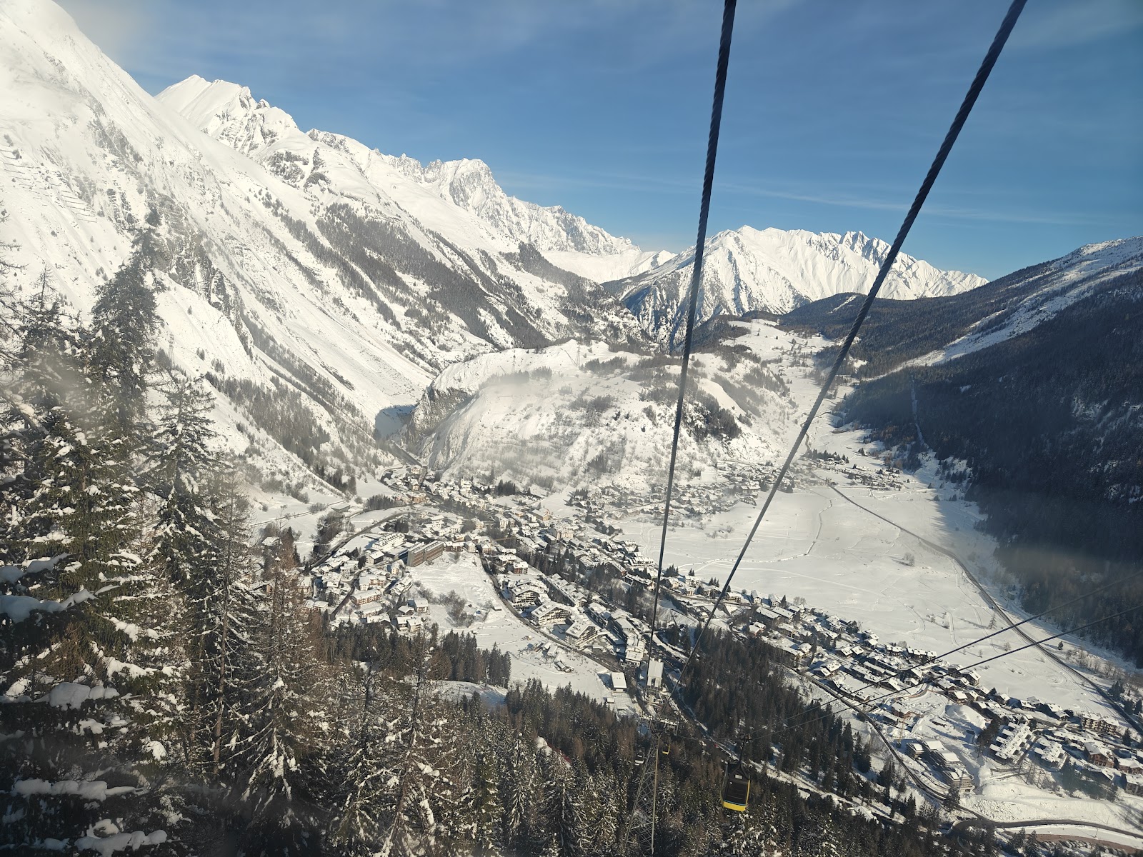 Empty north facing groomed pistes above La Thuile under blue sky