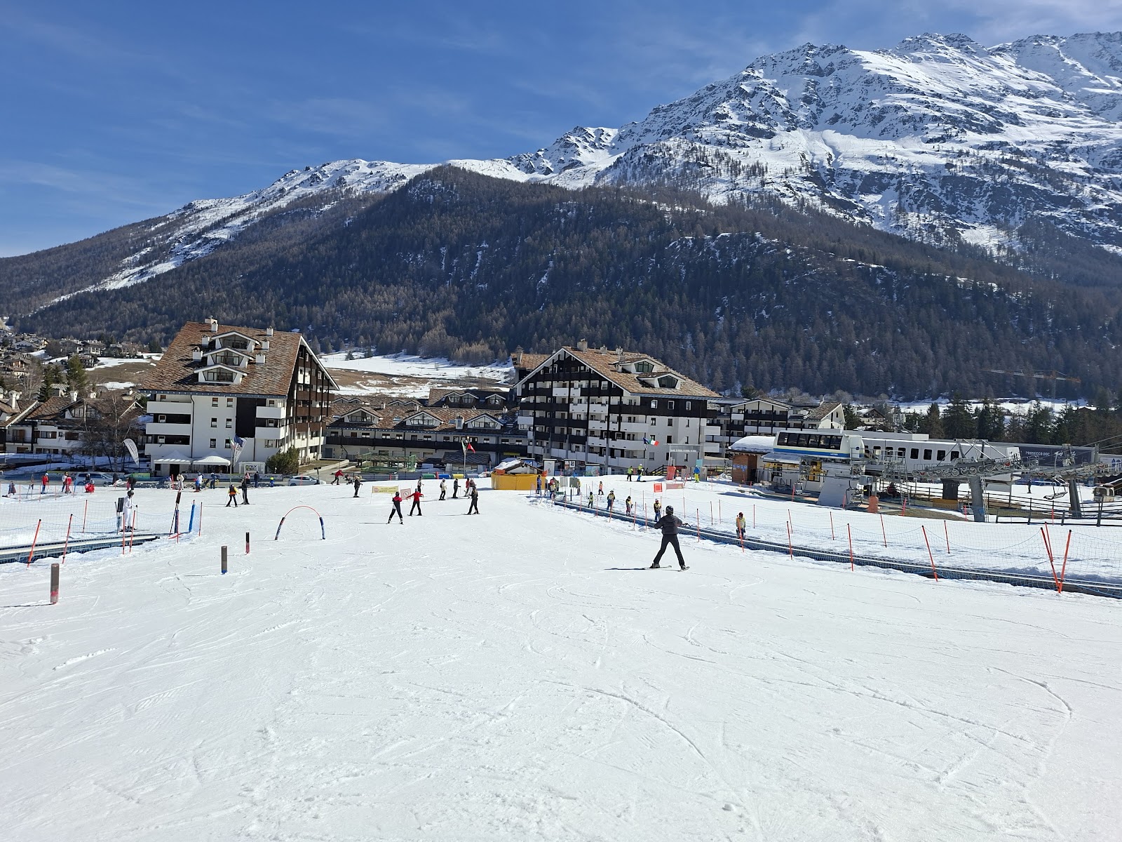 Skiers crossing the ridge between La Thuile and La Rosiere on the cross border link