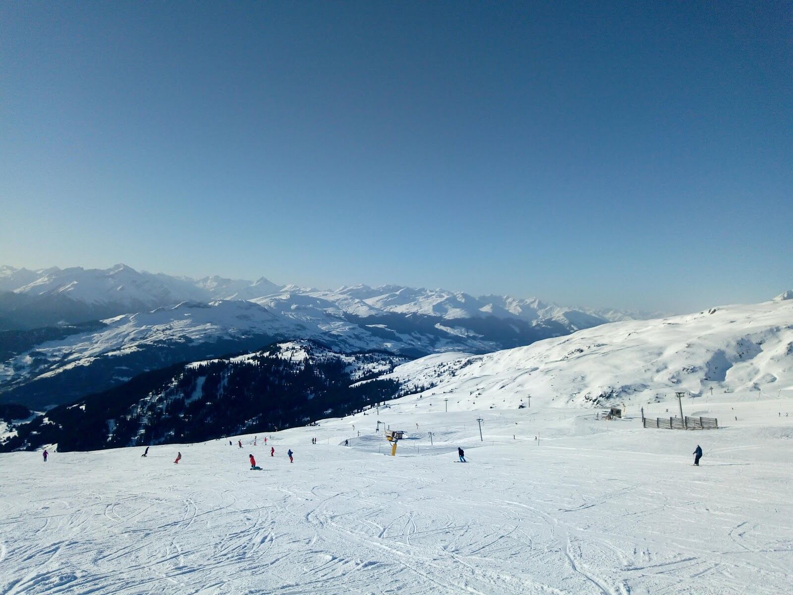 The wide modern ski area of Laax above the village in the Swiss Alps
