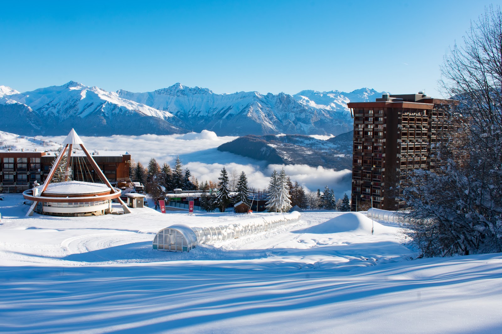 Wide sunny pistes above the ridge resort of Le Corbier