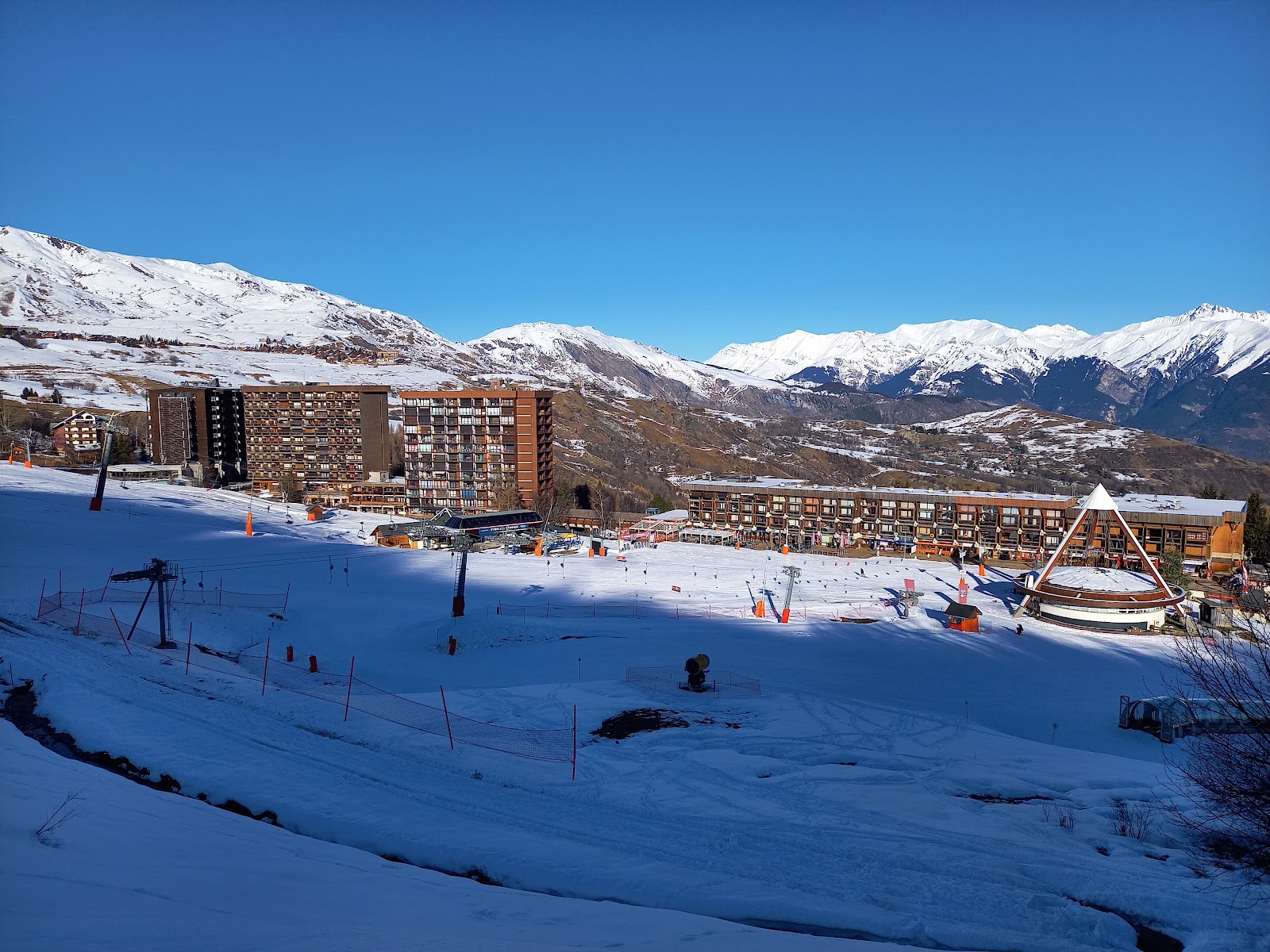 The linked ski area of Les Sybelles under blue sky