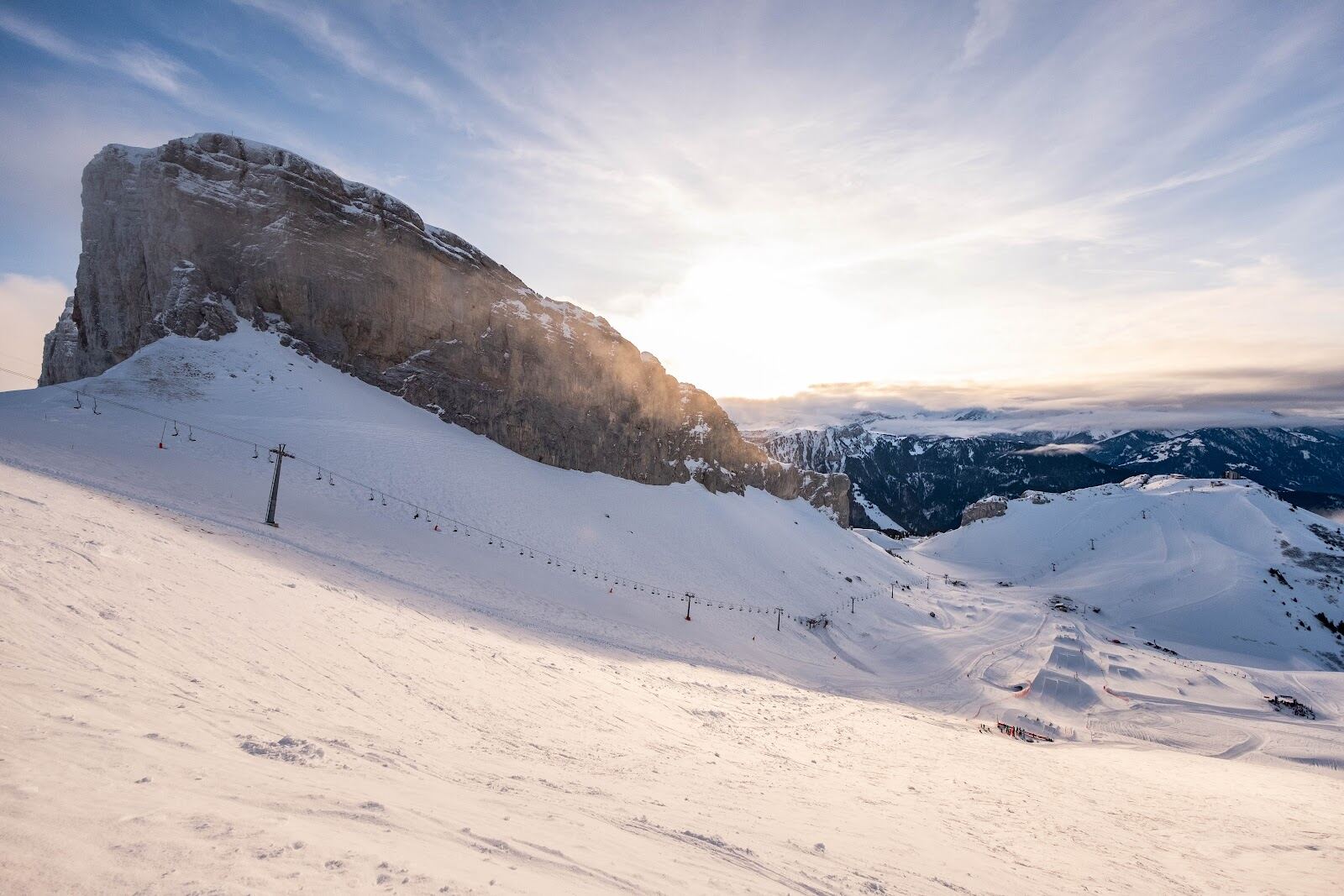 The sunny terraced village of Leysin above the Rhone valley with the Tour d Ai cliffs behind