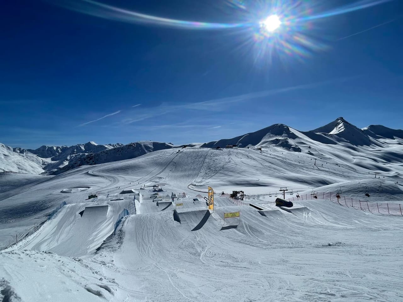 Snowboarders in the Livigno snowpark on the Mottolino side